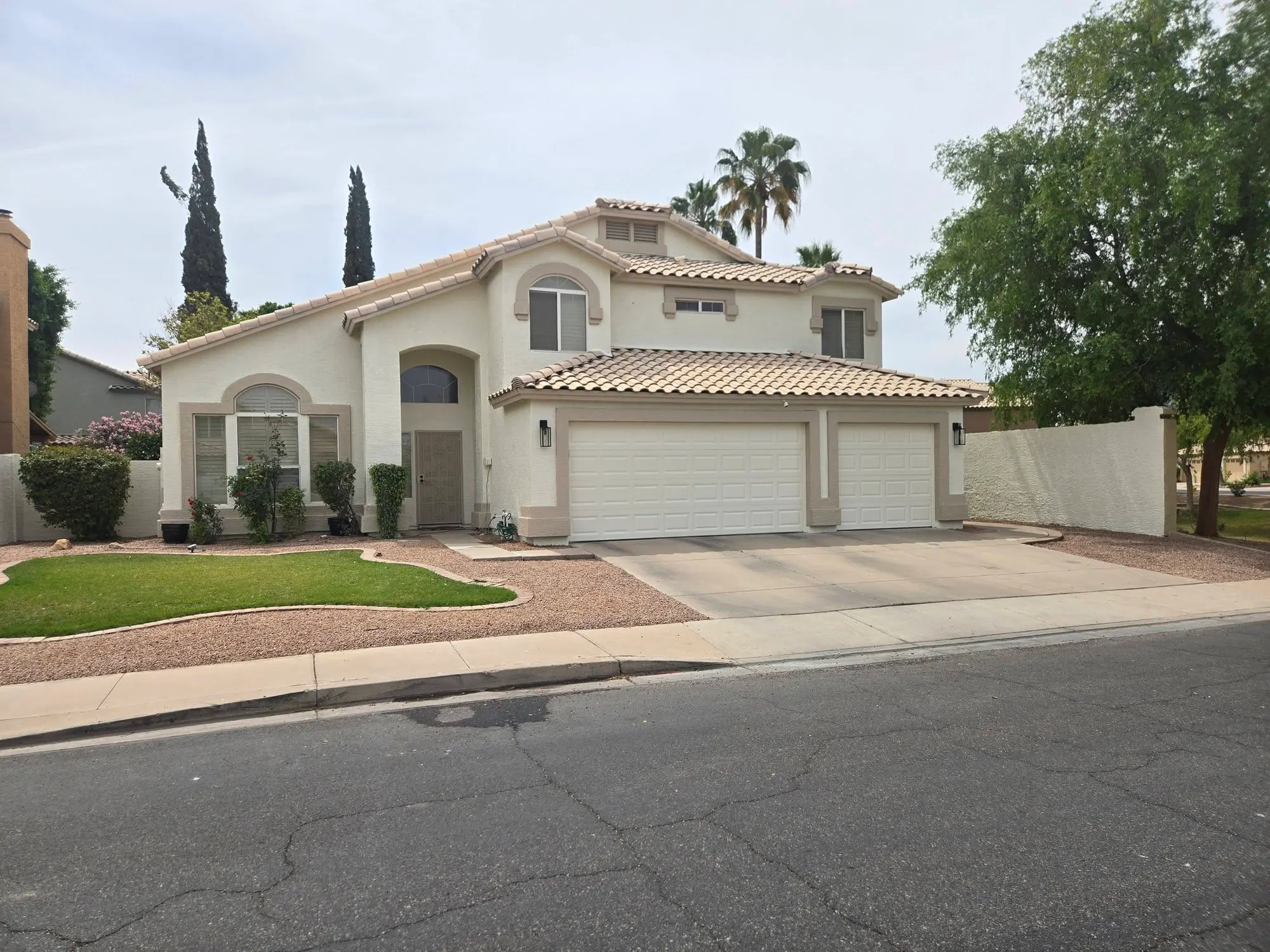 White stucco two-story home in the Phoenix area freshly painted by Lozano's Painting